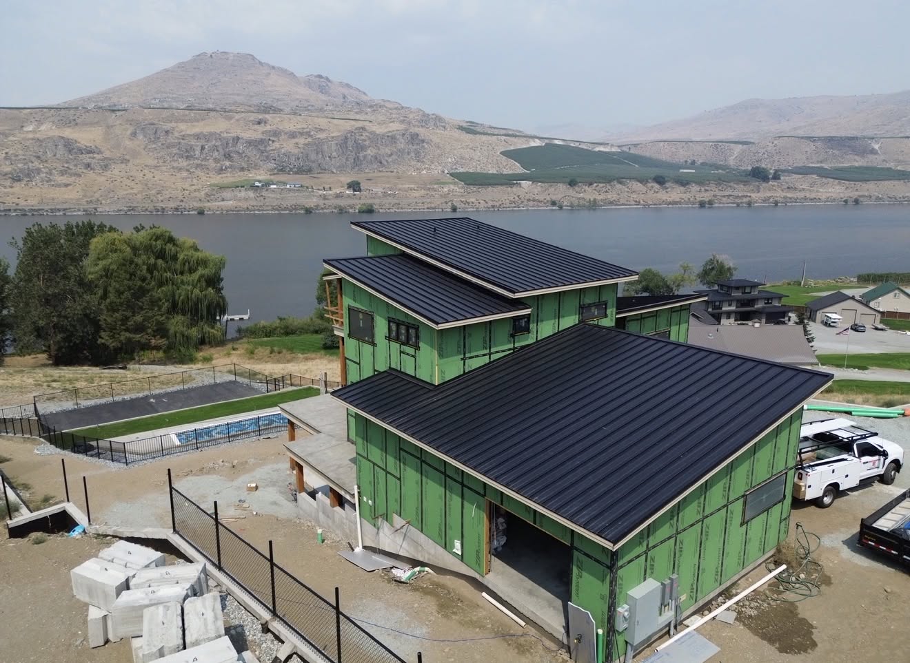 metal roof black standing seam modern home lake 2